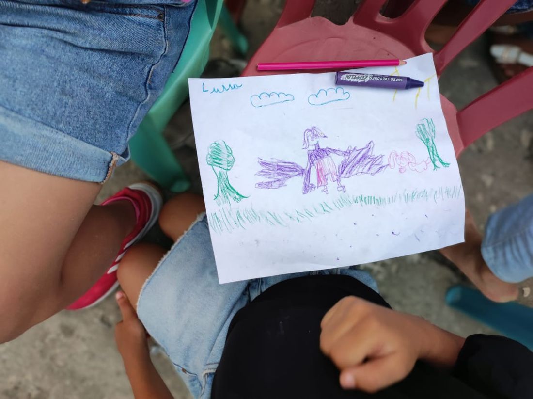 Dibujo de una niña con alas entre árboles